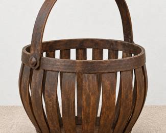 Rustic slatted wood basket with a curved carrying handle and dark finish.