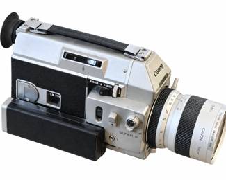 Canon Super 8 movie camera with zoom lens, carrying strap, and eyecup.