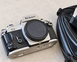 Nikon FG film camera body with a silver-and-black finish and body cap. Case included.
