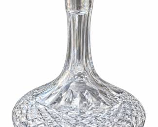 Wide round cut-glass decanter with a slender neck and faceted stopper.