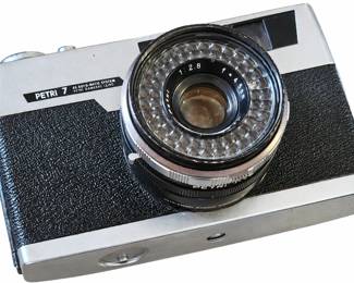 Petri 7 film camera with a 45mm f/2.8 lens, silver-and-black body, and textured grip panels.