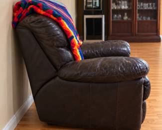 Dark Brown Recliner with Colorful Throw. Items sold separately. 