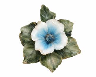 Pale blue ceramic flower ornament with green leaves