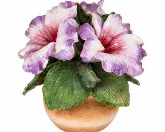 Pink ceramic flower ornament with green leaves