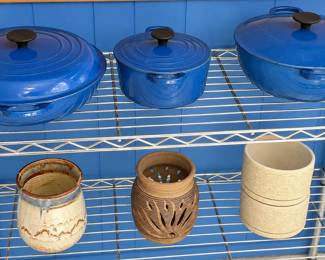 COOKWARE ◆ POTTERY  Blue lidded cookware in assorted sizes ◆ Cream glazed pottery vessel with blue and brown accents ◆ Pierced pottery luminary ◆ Two textured cream ceramic pots.