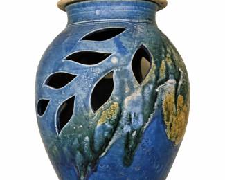 Ceramic vase with openings and lid
