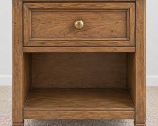 Wood nightstand with a carved drawer front, brass-tone knob, and roomy open lower shelf.