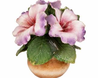 Pink ceramic flower ornament with green leaves