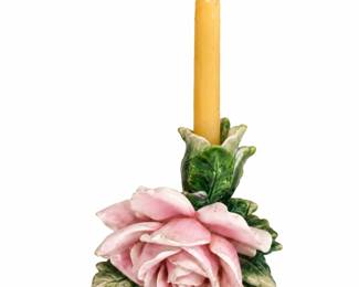 Pink Rose Candleholder — Sculpted ceramic rose with glossy green leaves and a yellow taper candle.