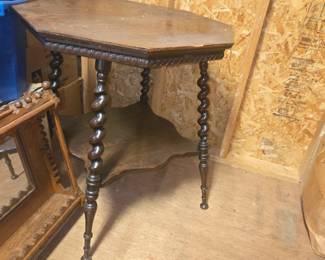antique hexagonal wooden two-tier side table, featuring a six-sided top, decorative carved trim, a lower scalloped shelf, and distinctive barley twist or bobbin-turned legs