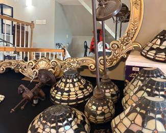 Tiffany-style stained glass lamp shades with an iridescent scalloped design and dark accent motifs, wall sconces