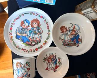 vintage 1969 Raggedy Ann and Andy melamine children's dish set made by Oneida Deluxe/Ware, featuring a large plate, two bowls, and a mug
