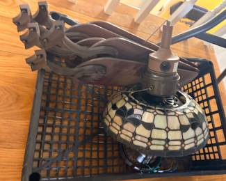 disassembled ceiling fan with a Tiffany-style stained glass light fixture and brown fan blades