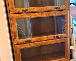 four-tier wooden barrister bookcase, also known as a lawyer's bookcase, featuring glass-front stackable or one-piece cabinet doors
