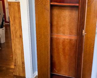 vintage Art Deco-style oak wardrobe or armoire, featuring characteristic geometric wooden inlay and curved top detailing