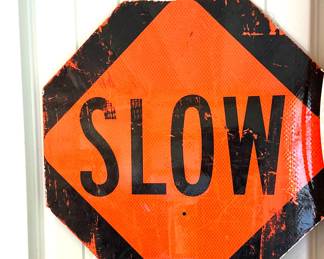Slow metal road sign