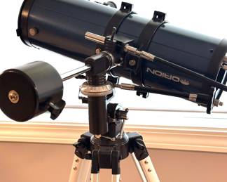 Orion reflector telescope with an equatorial mount, counterweight, manual adjustment controls, and adjustable aluminum tripod