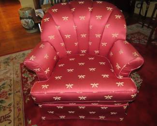 One of two matching armchairs with dragon fly fabric.