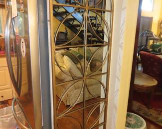 Metal framed arch shaped mirror.