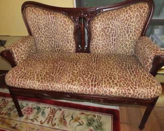 Leopard print antique setee.