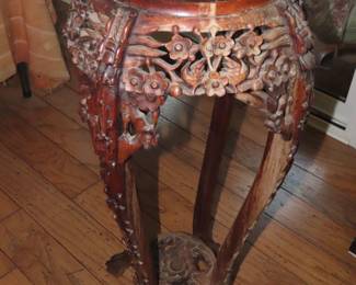 Tall antique plant stand heavily carved with marble top.
