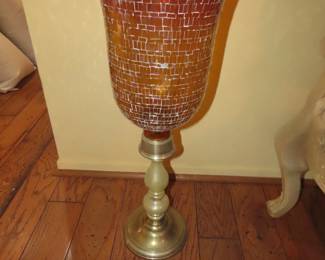 Tall galss vase on brass stand.