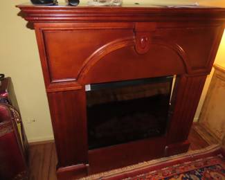 One of two electric fire places with wood surround mantle.