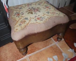 Embroidered foot stool.