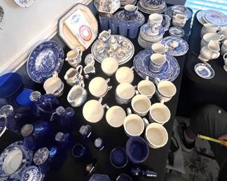 Large collection of blue and white transferware porcelain, including teacups, saucers, plates, pitchers, and serving pieces