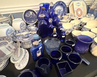 Large collection of blue and white transferware porcelain, including teacups, saucers, plates, pitchers, and serving pieces