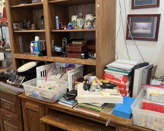 Oak desk unit with assorted office supplies