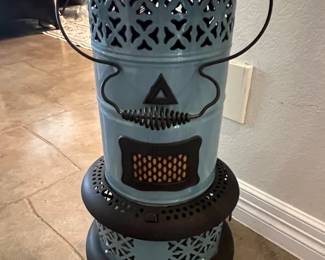 Vintage Perfection kerosene heater featuring a light blue enameled body with black cast iron trim, wire handle, and footed base.