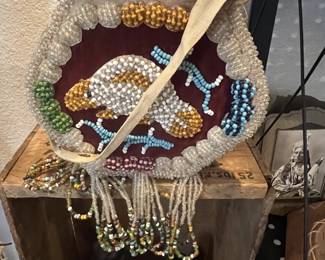 Vintage Native American style beaded purse featuring a bird motif on a red velvet background, complete with a fabric strap and long beaded fringe.