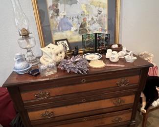 Antique three-drawer wooden dresser with two-tone finish and ornate metal pulls