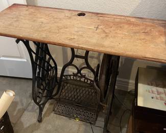 Vintage Victor treadle sewing machine base repurposed with a rustic wooden tabletop