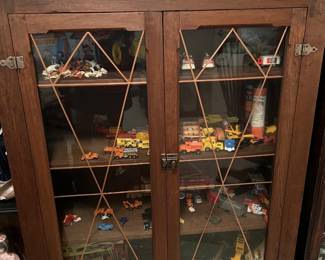 Vintage oak display cabinet with glass doors featuring geometric wood mullions
