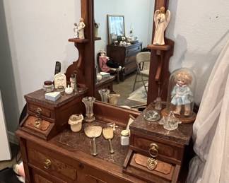 Antique Eastlake-style Victorian walnut dresser featuring a tall swivel mirror, marble-top side glove boxes, and burl wood drawer fronts with brass ring pulls.
