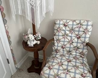 Vintage wooden armchair and wooden floor table lamp with lace shade