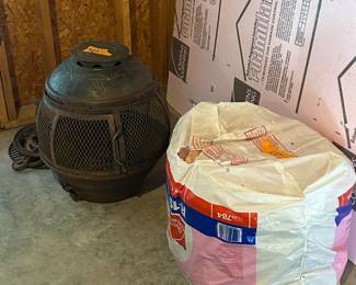 Outdoor Fire Pit and Roll of new insulation. Located in basement 