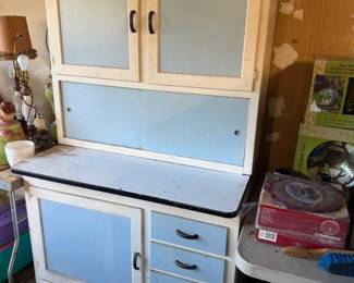 Vintage Ca. 1930's Era Hoosier Cabinet style kitchen cabinet featuring a white and light blue painted finish, enamel work surface, and original hardware.