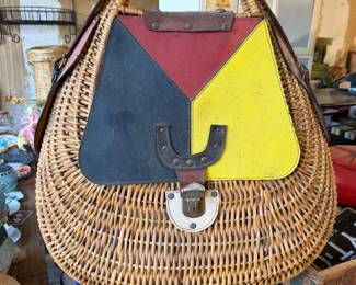 Vintage wicker handbag featuring a color-blocked leather flap in red, yellow, and black with a metal clasp closure.