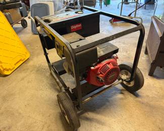Dayton portable generator powered by a red Honda 11.0 HP engine, mounted on a wheeled black metal cart frame.