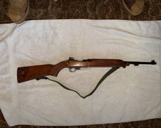 Ruger 10/22 semi-automatic rifle with a wooden stock.