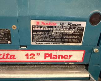 Makita Model 2012 12-inch thickness planer, showing the manufacturer's specification label and warning plate.