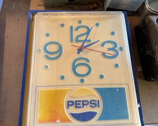 Vintage Pepsi-Cola light-up advertising wall clock, featuring a blue frame and the classic Pepsi logo, circa 1970s.