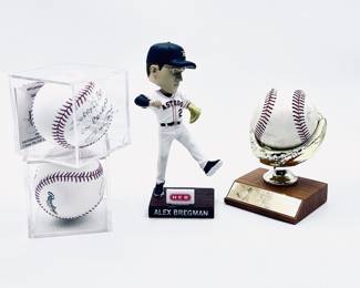 Baseballs with Signatures , Pete Rose , Nolan Ryan , and a Alex Bregman Bobble head in the center