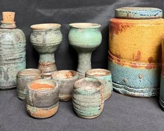 handmade stoneware features a striking mix of textured teal, rust, and warm ochre glazes