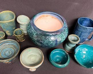handcrafted ceramic pottery pieces featuring shades of blue and green reactive glazes.