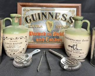 vintage Irish whiskey ceramic crocks, a Guinness mirror sign, and classic barware accessories