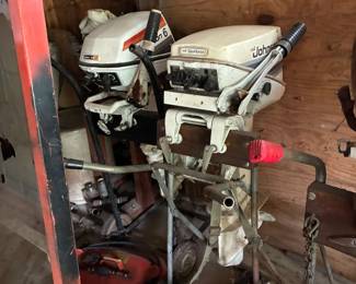 there are 4 Johnson outboard motors and outboard stands
